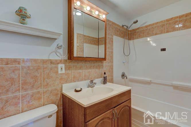 32 Ashley Road Edison, NJ 08817 - Photo 36 of 41 a bathroom with a sink a mirror and a shower