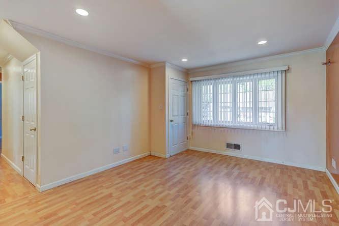 32 Ashley Road Edison, NJ 08817 - Photo 5 of 41 a view of an empty room with wooden floor and a window