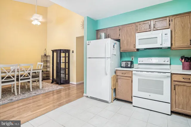 a utility room with cabinets washer and dryer
