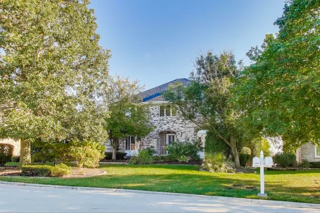 a view of a big building with large trees