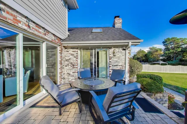 a view of backyard with outdoor seating and trees