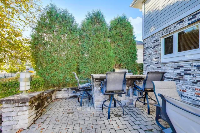 a view of a patio with table and chairs and potted plants