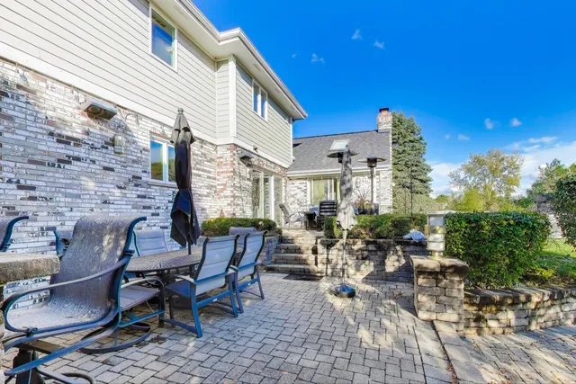 a view of a house with backyard swimming pool and sitting area