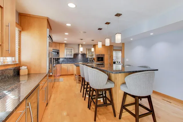 a large kitchen with a table and chairs