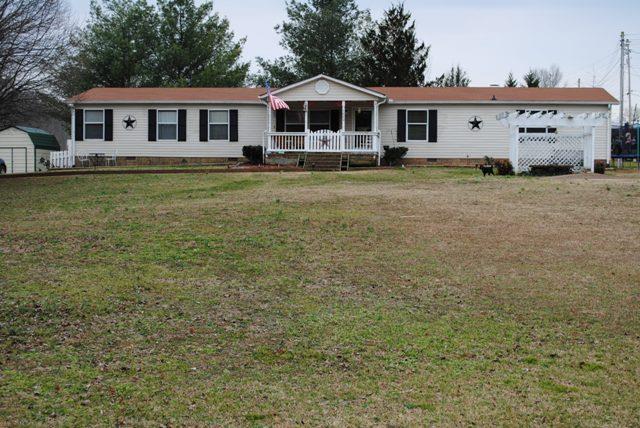 1000 Kaity Brooke Road Portland, TN 37148 - Photo 1 of 19 a front view of a house with a garden