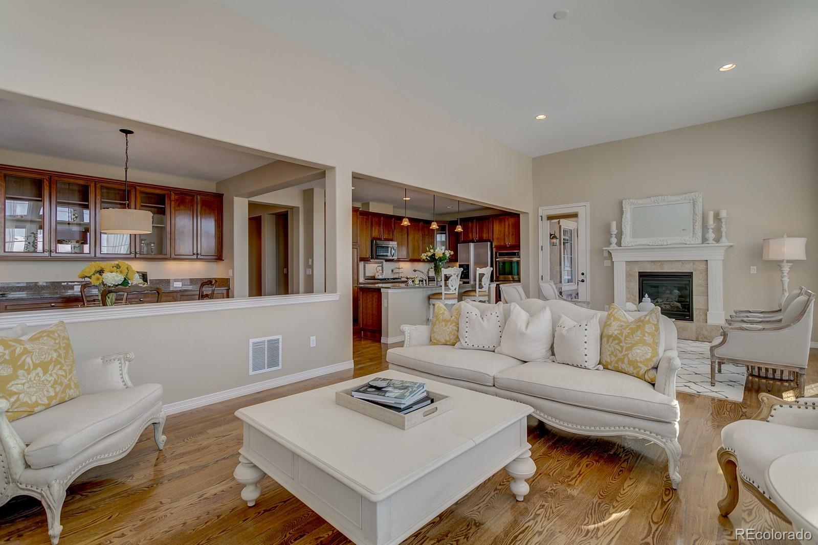 10687 Sundial Rim Road Highlands Ranch, CO 80126 - Photo 4 of 32 a living room with furniture and a wooden floor