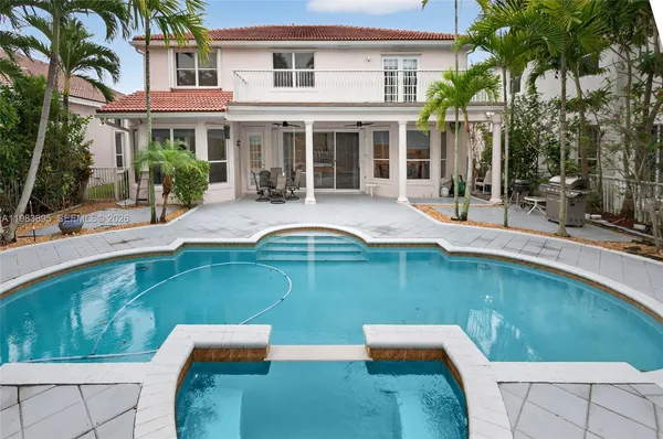 a swimming pool with outdoor seating and yard