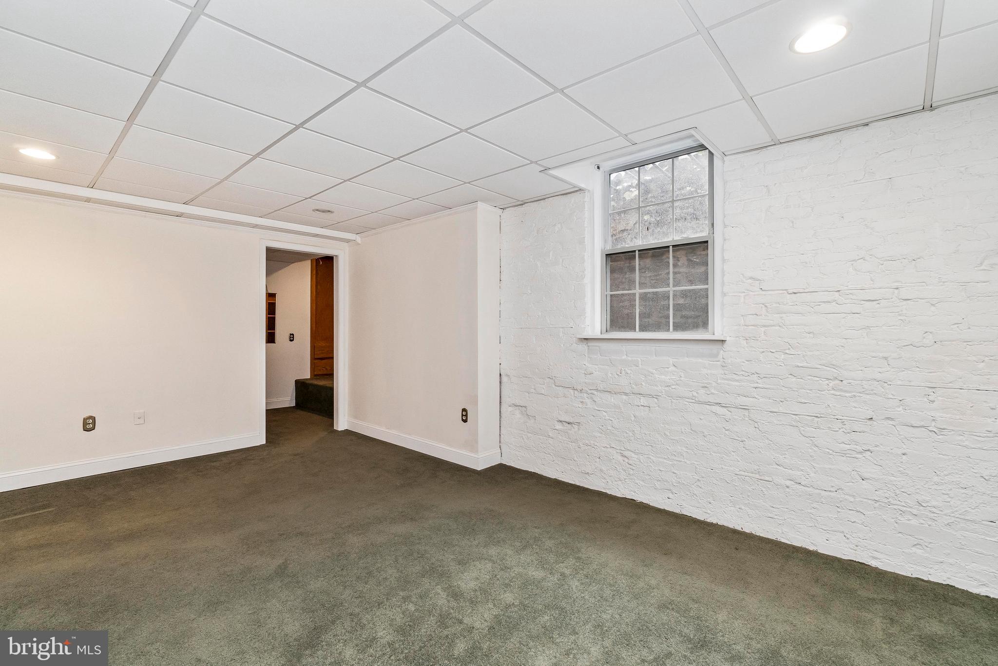 221 Ridgemede Road, Unit 204 Baltimore, MD 21210 - Photo 16 of 18 Large Master Bedroom with Exposed Brick