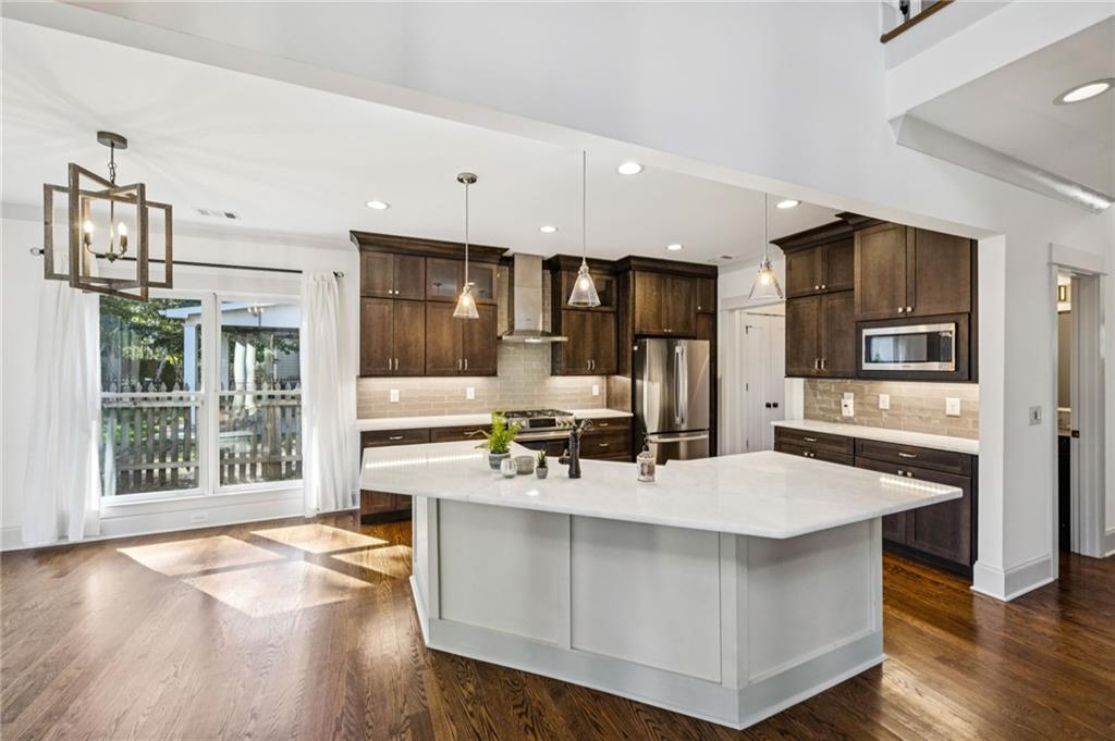 213 Ohm Avenue Avondale Estates, GA 30002 - Photo 14 of 43 a kitchen with a sink stove and refrigerator