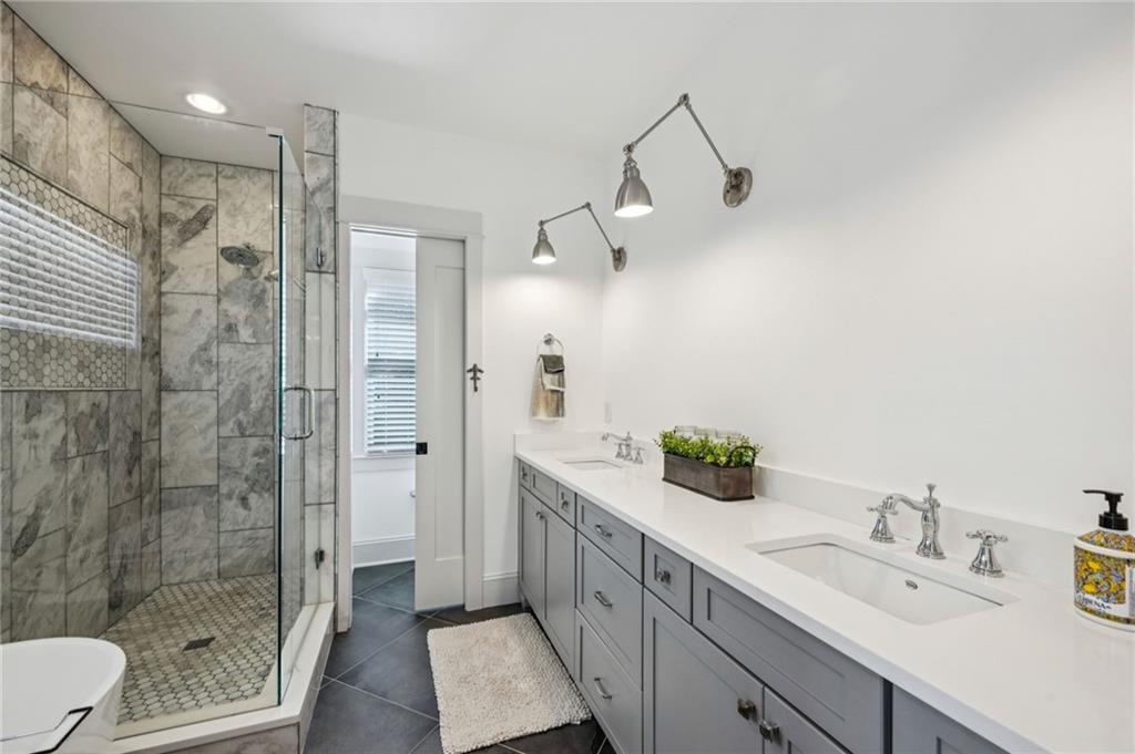 213 Ohm Avenue Avondale Estates, GA 30002 - Photo 20 of 43 a bathroom with a double vanity sink toilet and shower