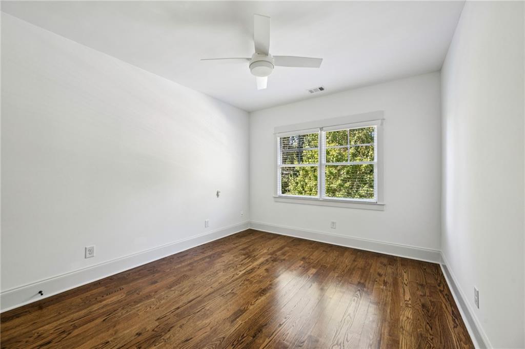 213 Ohm Avenue Avondale Estates, GA 30002 - Photo 25 of 43 an empty room with wooden floor and windows