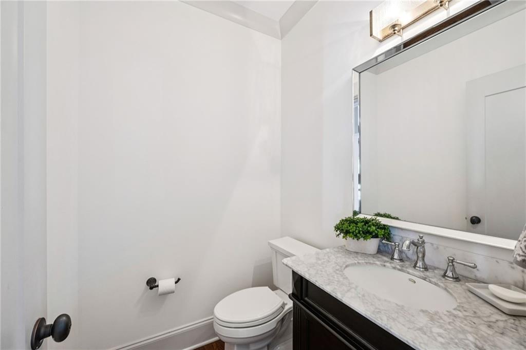 213 Ohm Avenue Avondale Estates, GA 30002 - Photo 7 of 43 a bathroom with a granite countertop sink vanity mirror and toilet