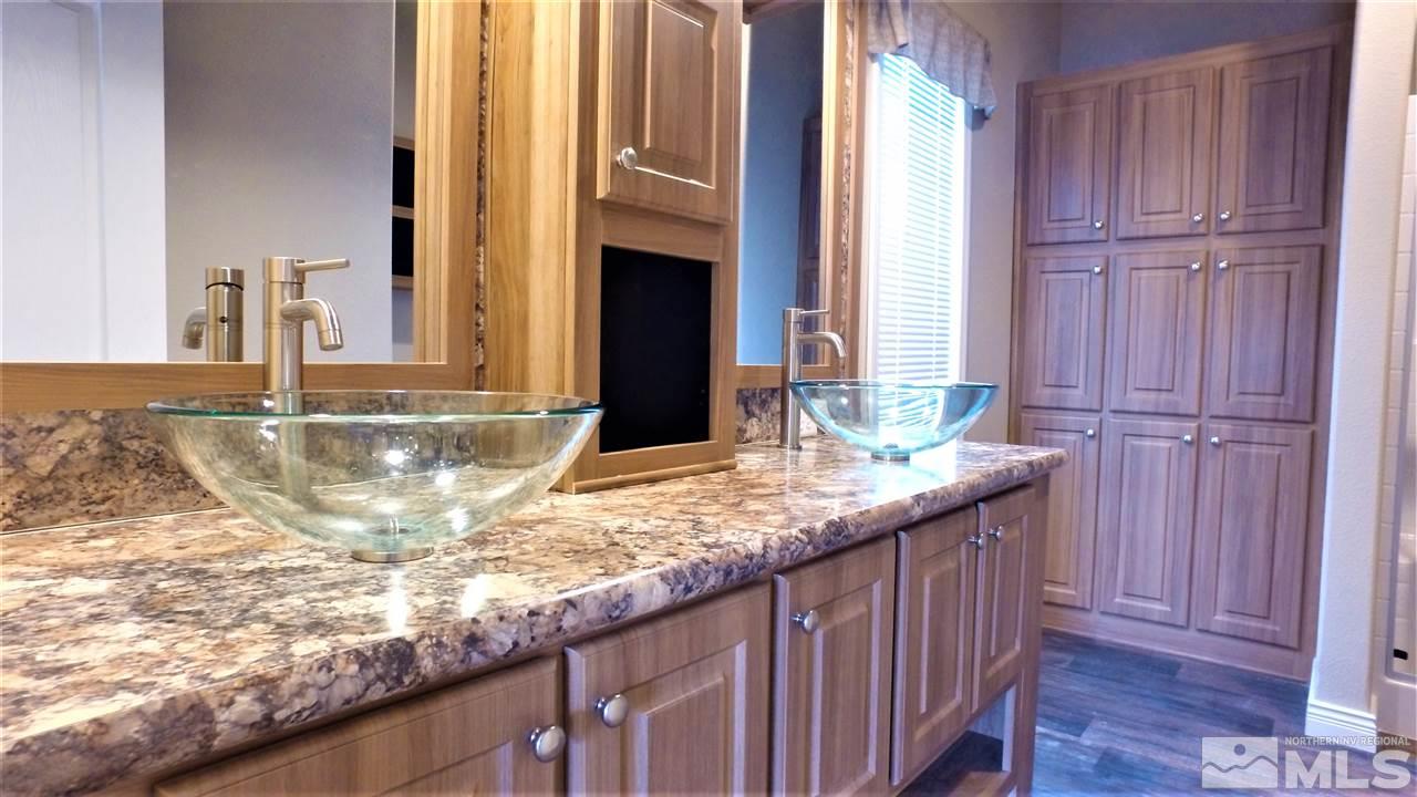 3920 Goldfinch Drive Reno, NV 89508 - Photo 8 of 16 a bathroom with a granite countertop sink and a mirror