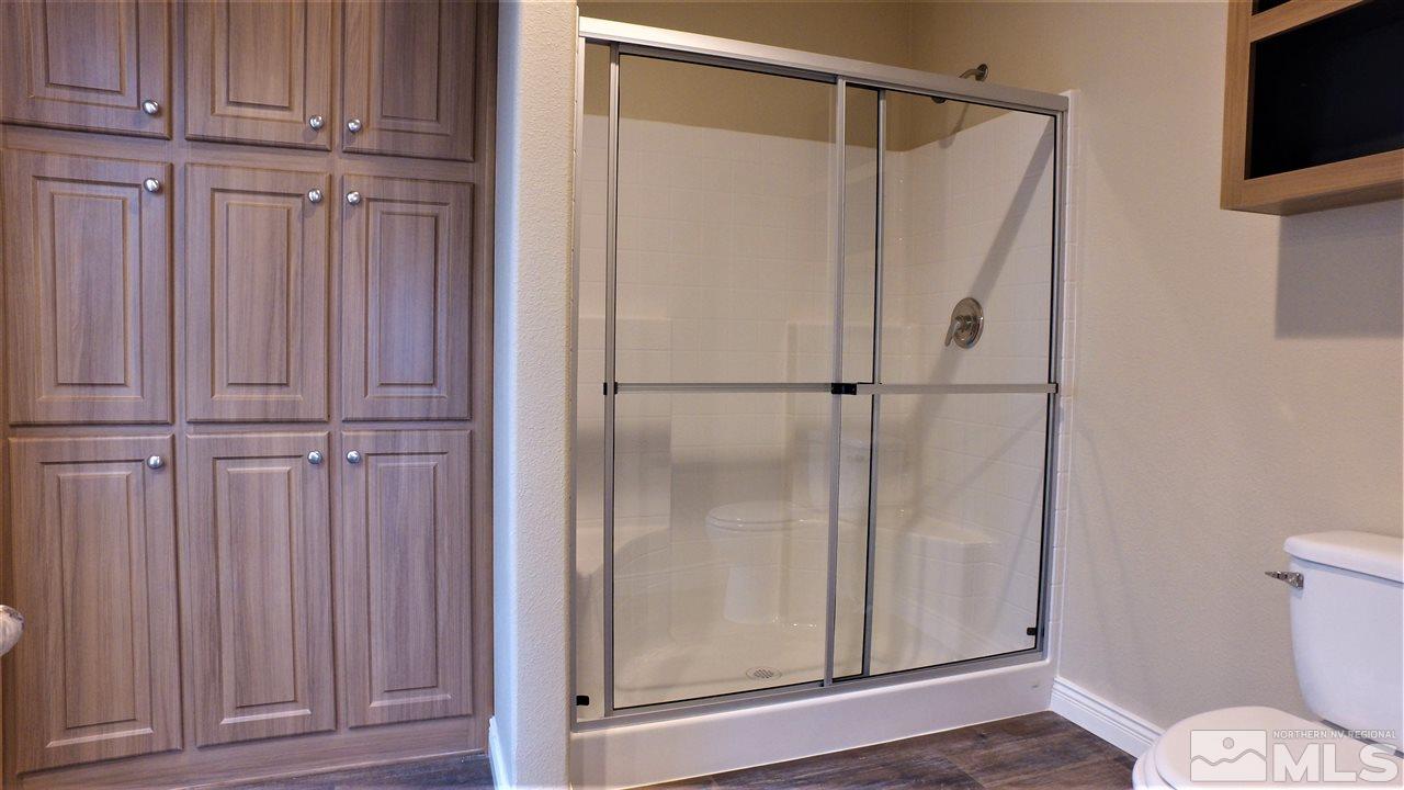 3920 Goldfinch Drive Reno, NV 89508 - Photo 9 of 16 a bathroom with a glass door shower