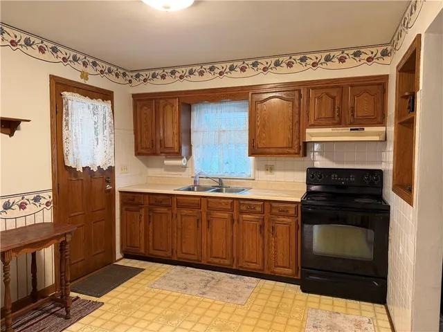 a kitchen with stainless steel appliances granite countertop a stove and a sink