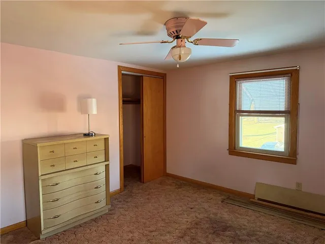 a view of an empty room with a dresser