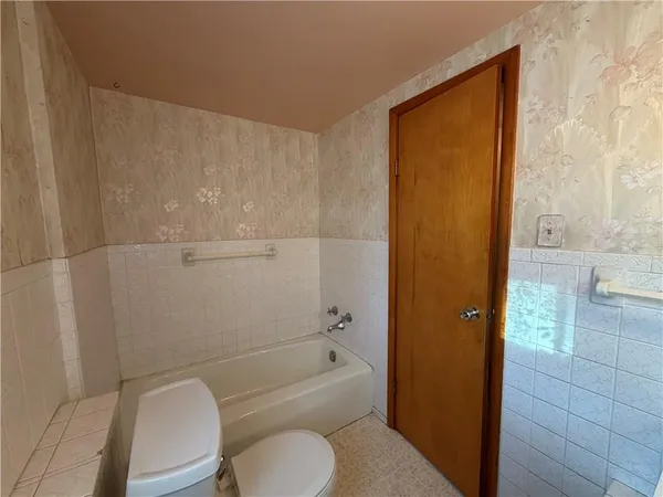 a bathroom with a toilet a sink and bathtub