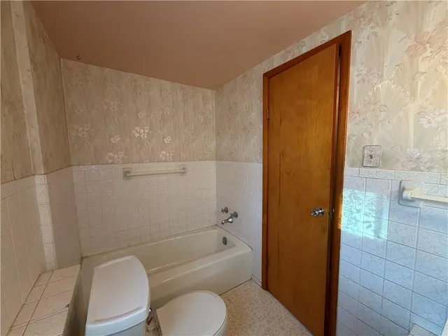 a bathroom with a toilet a sink and bathtub