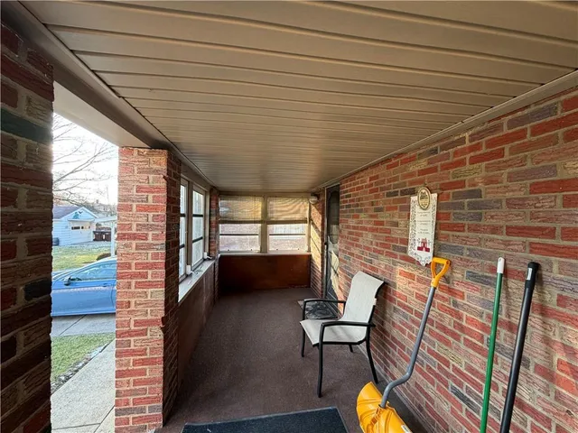 a balcony with chairs and wooden floor