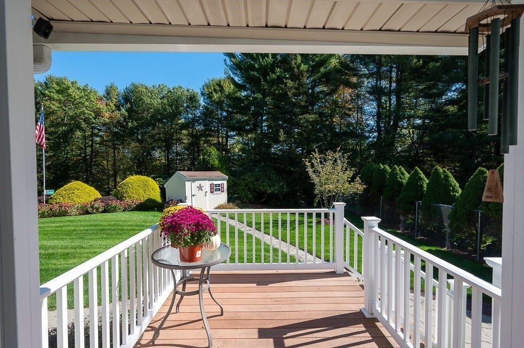 62 Larned Road Oxford, MA 01540 - Photo 25 of 42 a view of a deck with a table and chair under an umbrella