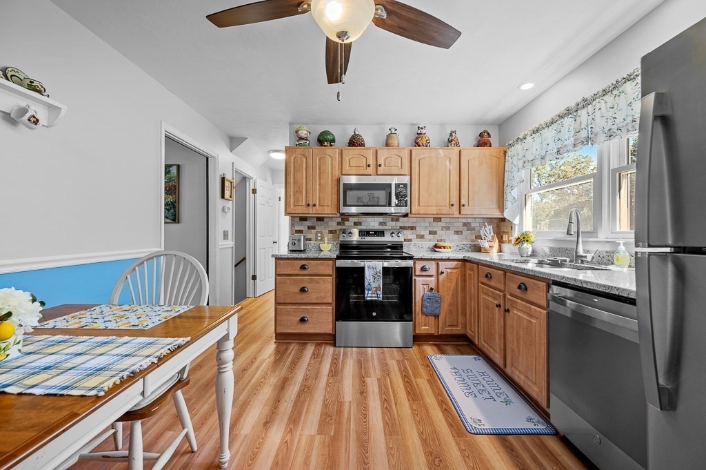 62 Larned Road Oxford, MA 01540 - Photo 9 of 42 a kitchen with stainless steel appliances kitchen island granite countertop a sink stove and refrigerator