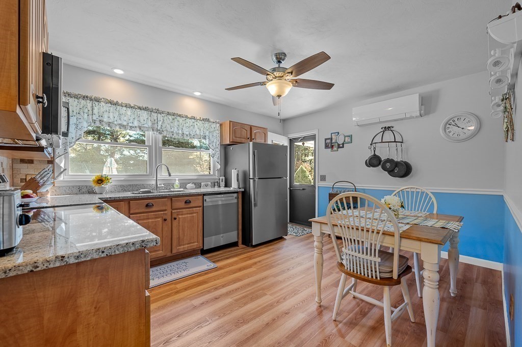62 Larned Road Oxford, MA 01540 - Photo 10 of 42 a kitchen with stainless steel appliances granite countertop a kitchen island hardwood floor and a sink
