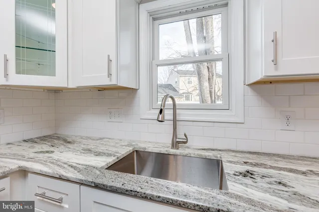 a kitchen with granite countertop a sink and a window