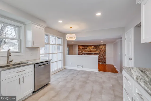 a kitchen with granite countertop a sink and cabinets