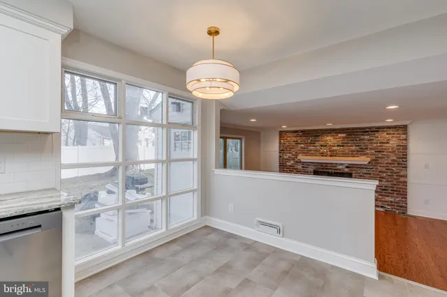a kitchen with stainless steel appliances granite countertop a stove and cabinets