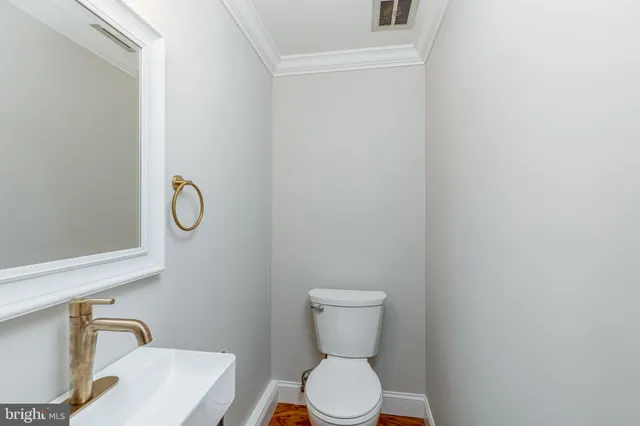a white toilet sitting next to a bathroom sink