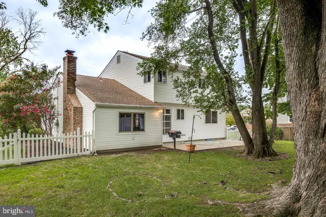 a white house that has sink in front of it