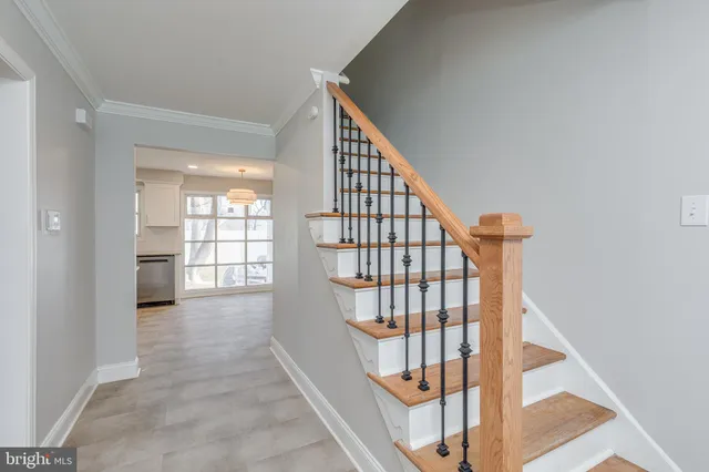 a view of staircase with white walls and a window
