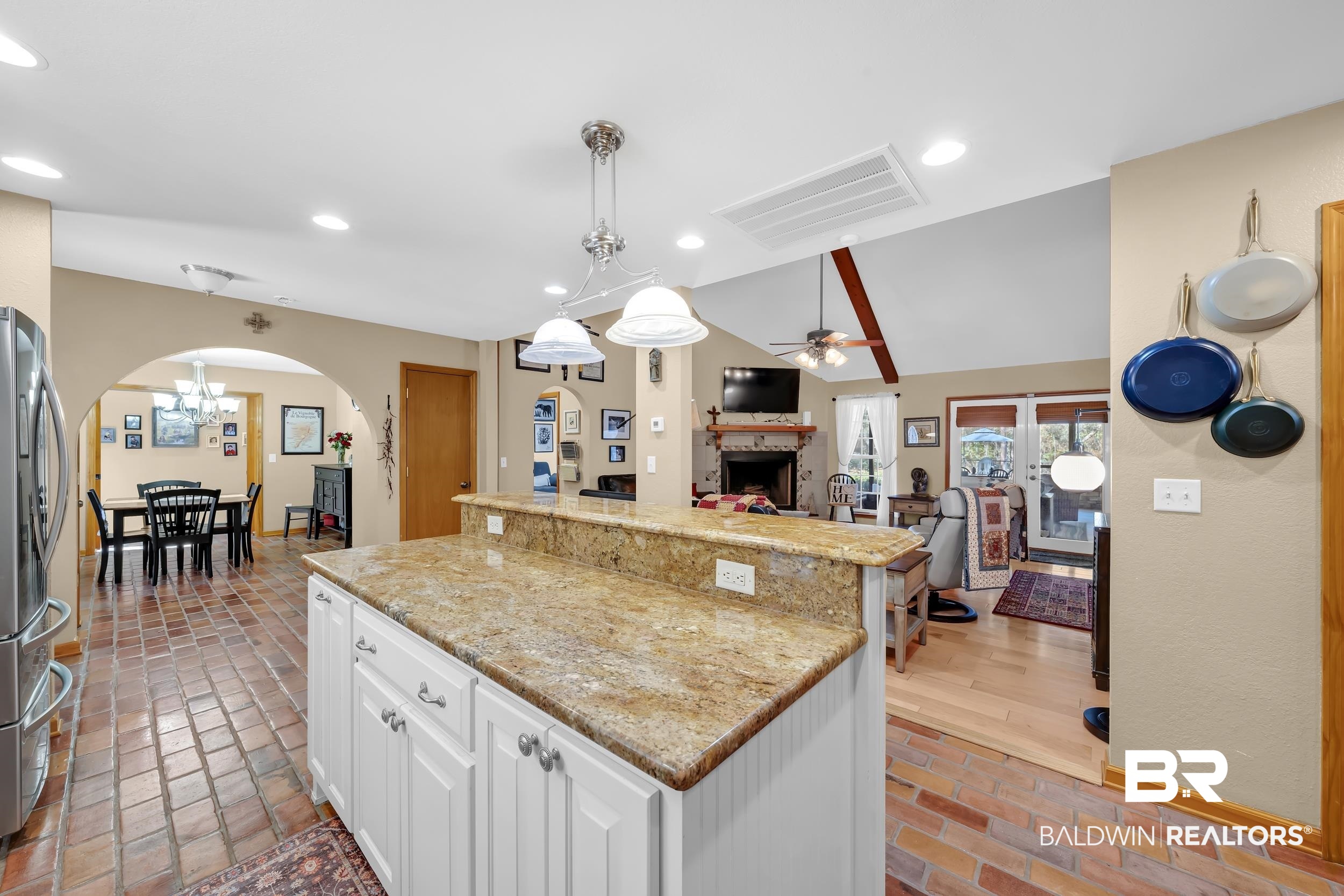22929 Highway 98 Foley, AL 36535 - Photo 54 of 54 Kitchen with lofted ceiling, brick flooring, white cabinets, freestanding refrigerator, and open floor plan