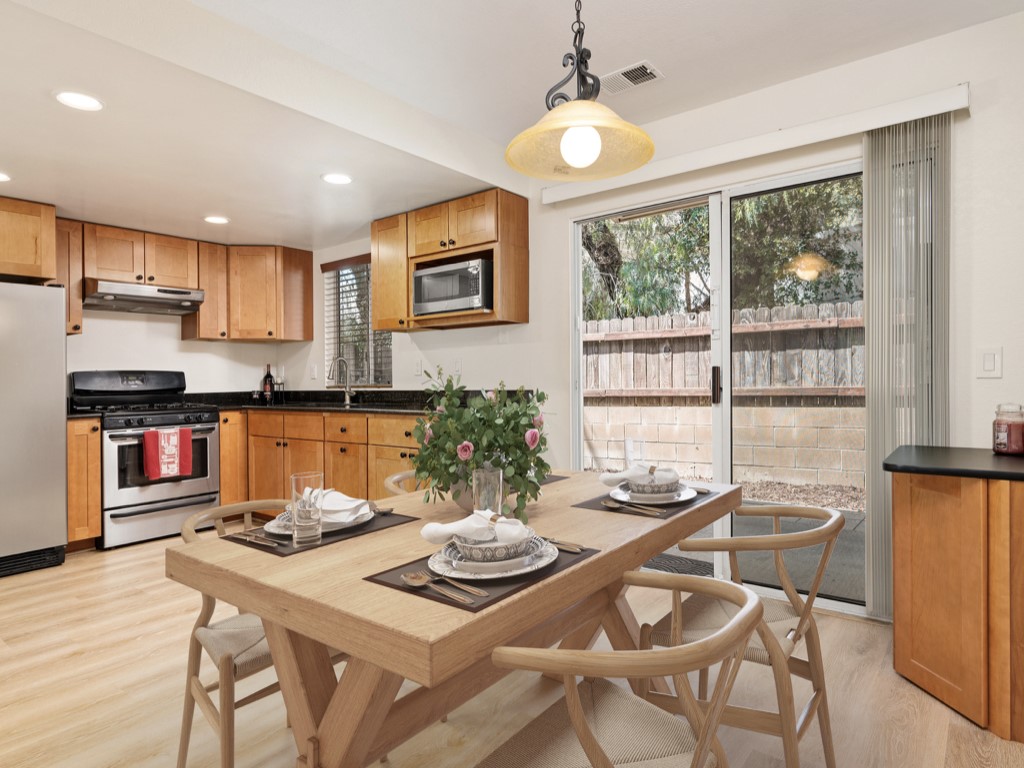 a view of a dining room with furniture and a potted plant