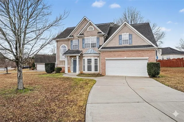 a front view of a house with a yard