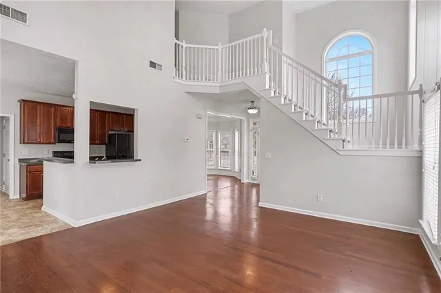 a view of entryway and hall with wooden floor