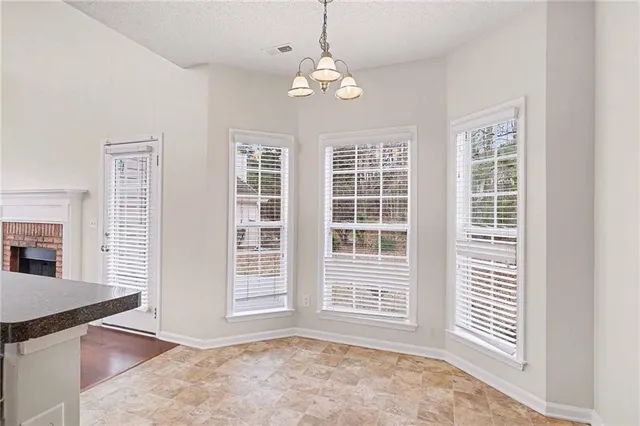a view of a kitchen with granite countertop wooden cabinets and a stainless steel appliances