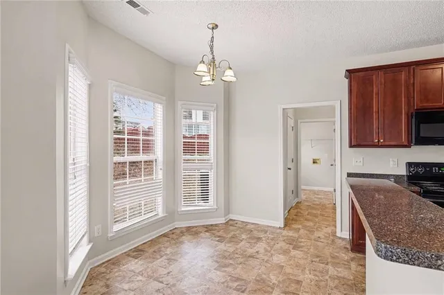 a kitchen with stainless steel appliances granite countertop a stove sink and cabinets