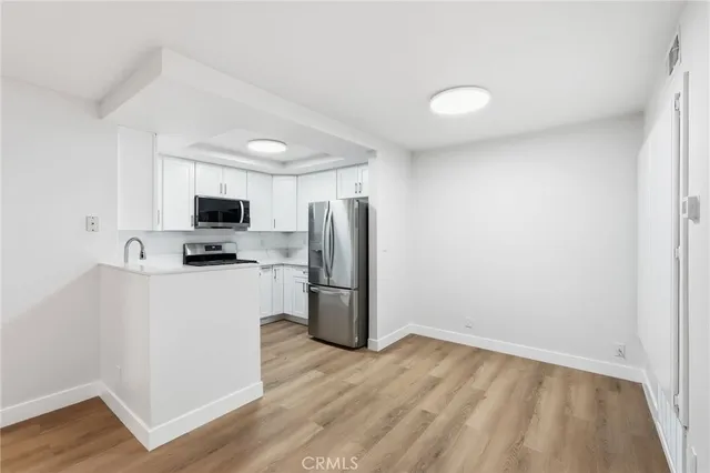 a view of kitchen with wooden floor