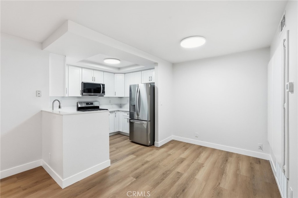 15511 Sherman Way, Unit 19 Van Nuys, CA 91406 - Photo 11 of 31 a view of kitchen with wooden floor