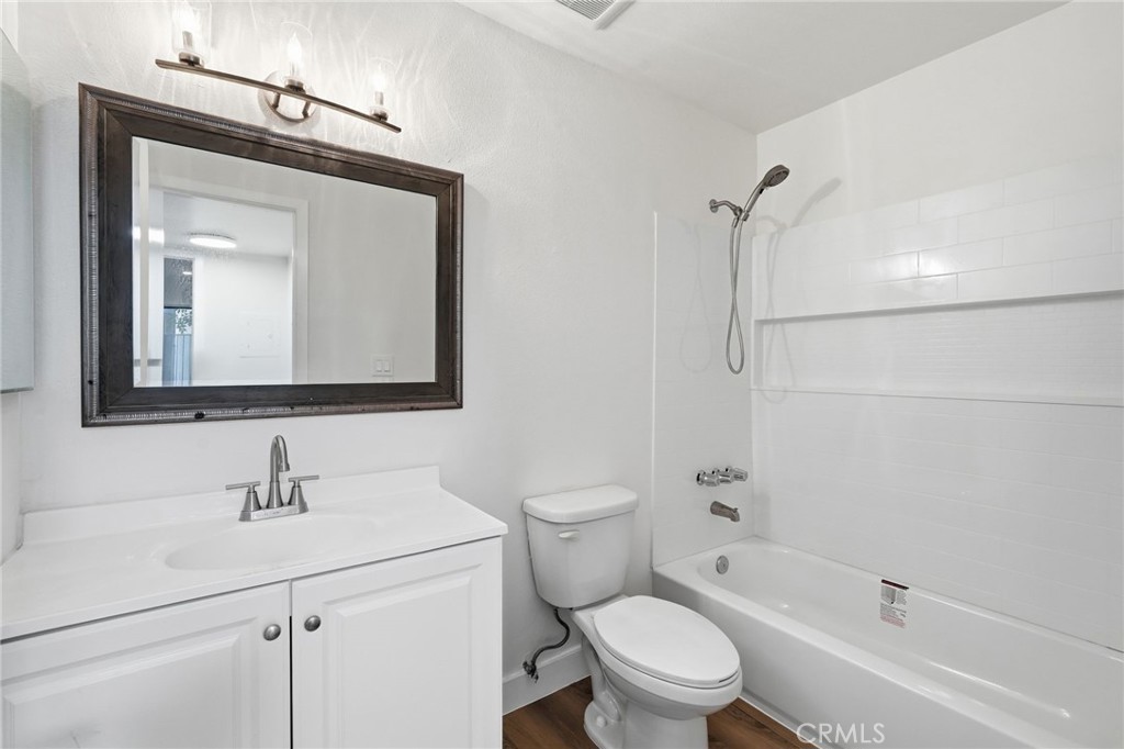 15511 Sherman Way, Unit 19 Van Nuys, CA 91406 - Photo 21 of 31 a bathroom with a toilet sink vanity tub and shower