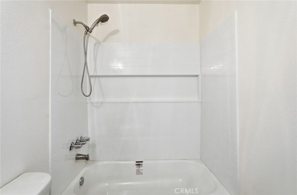15511 Sherman Way, Unit 19 Van Nuys, CA 91406 - Photo 22 of 31 a bathroom with a bath tub with a shower
