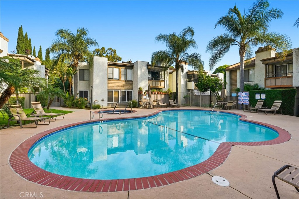15511 Sherman Way, Unit 19 Van Nuys, CA 91406 - Photo 27 of 31 a view of a swimming pool with a lounge chairs