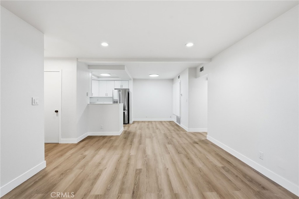 15511 Sherman Way, Unit 19 Van Nuys, CA 91406 - Photo 10 of 31 a view of an empty room with wooden floor