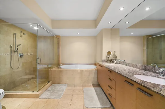 a spacious bathroom with a granite countertop sink mirror and shower