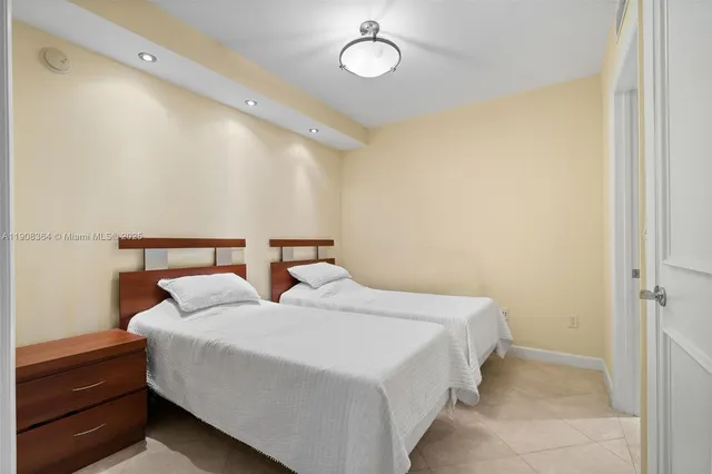 a bedroom with two beds and painted walls