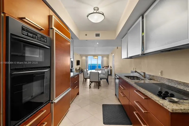a kitchen with stainless steel appliances a stove a sink and a microwave