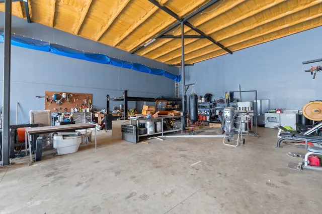 a living room with furniture a flat screen tv and a table