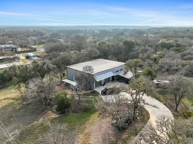 an aerial view of a house with a yard
