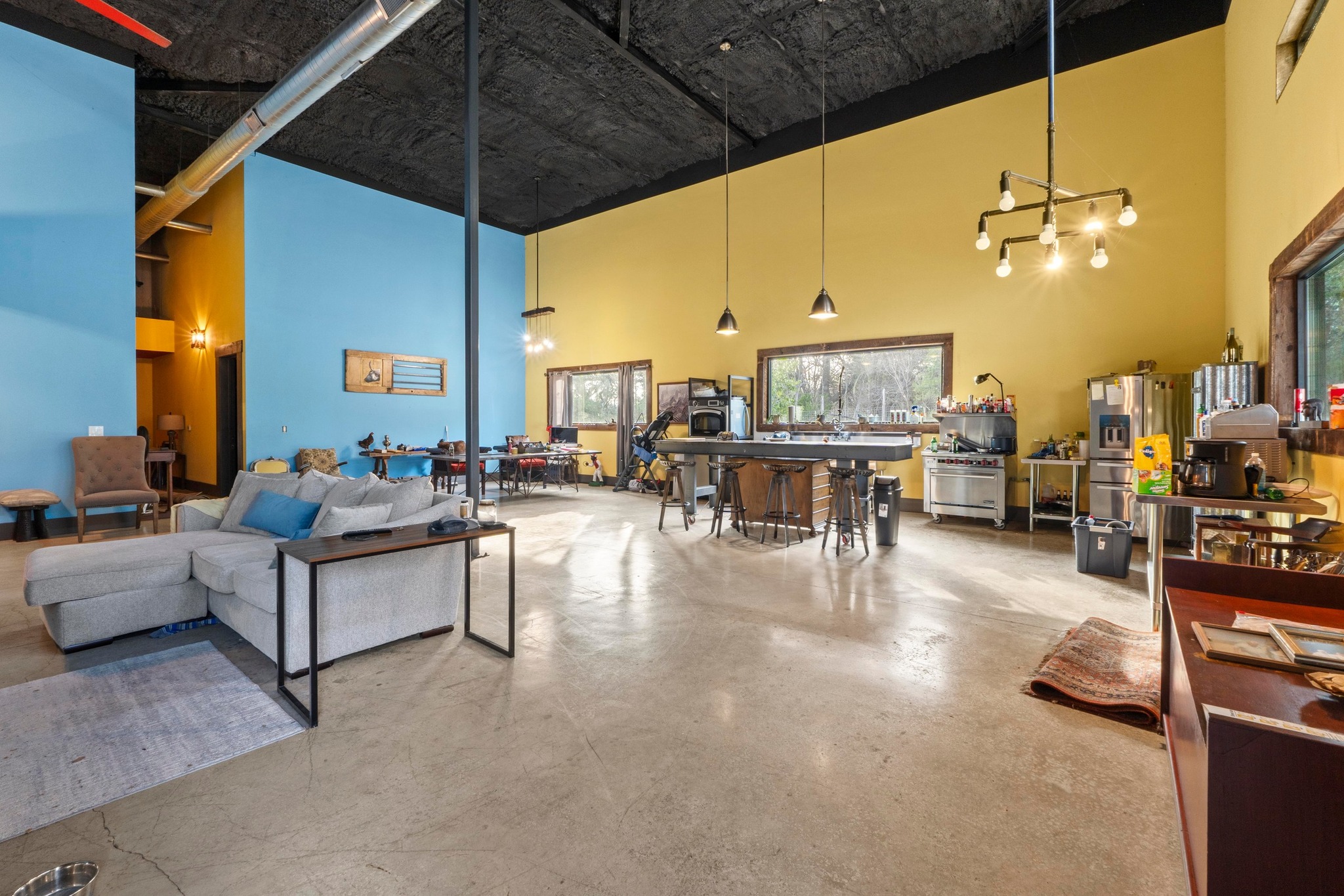 12302 Bethel Church Road Manchaca, TX 78652 - Photo 6 of 35 a living room with furniture a chandelier and a dining table